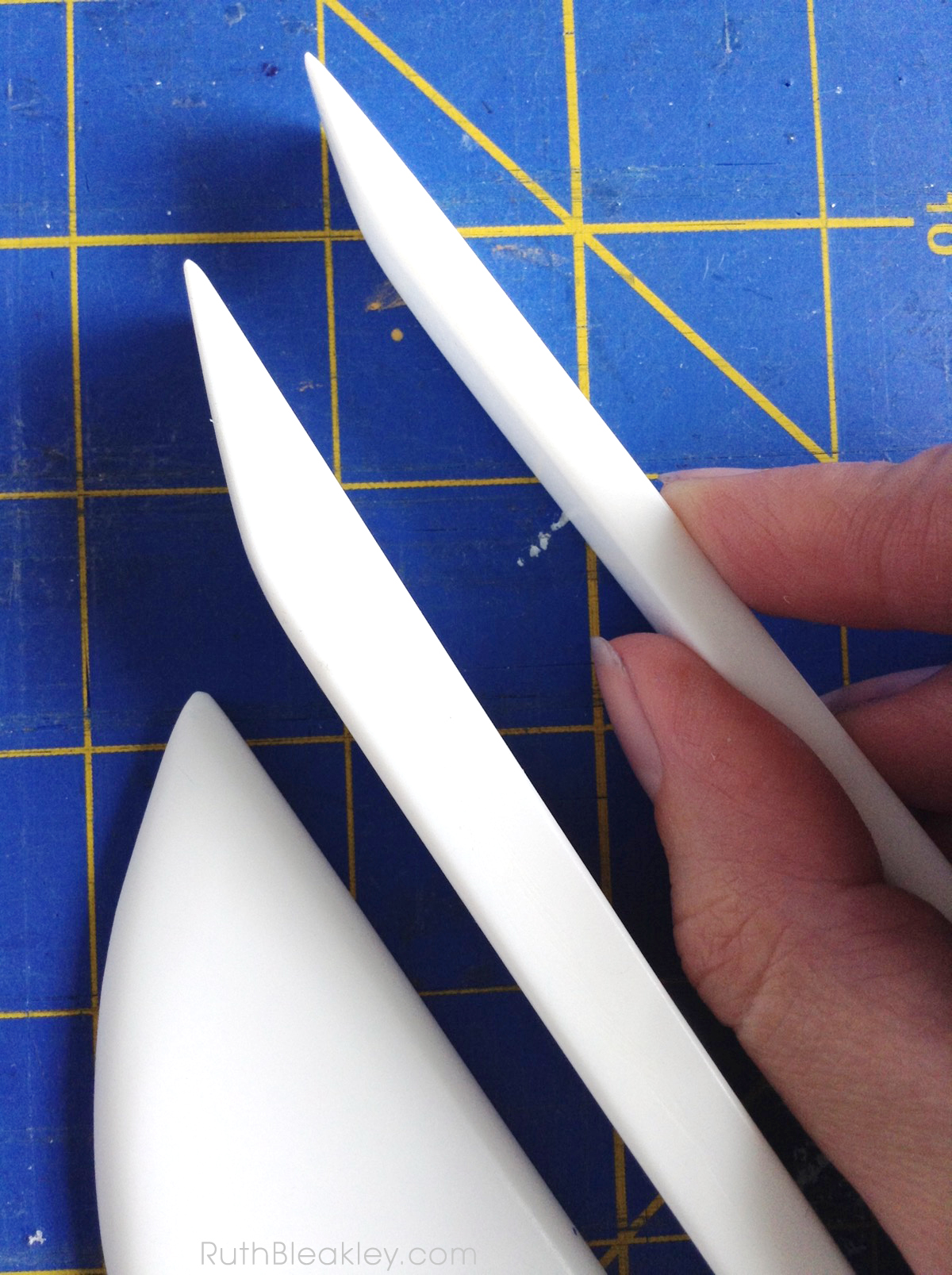 comparing teflon folder shapes - these are the perfect tool for bookbinding