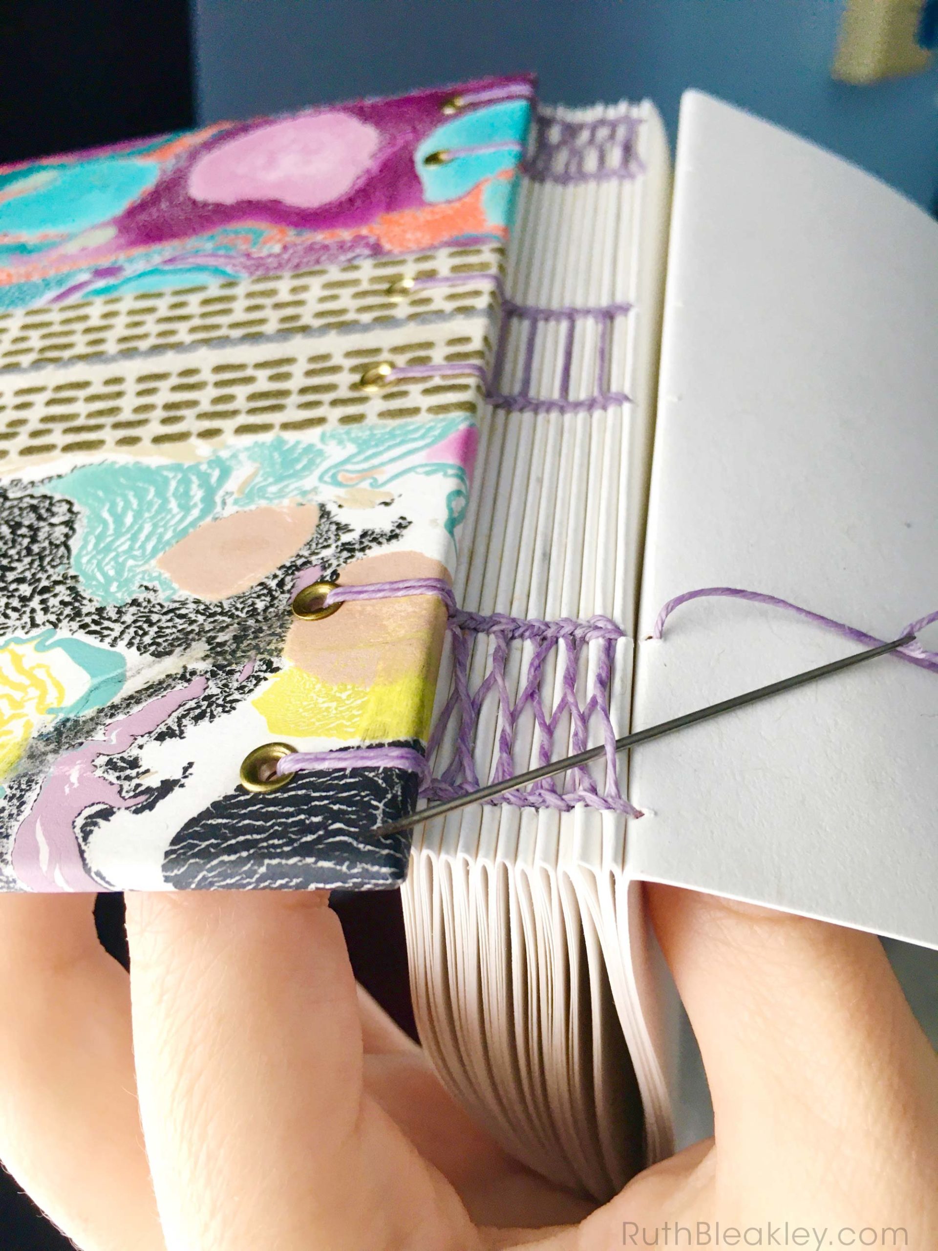 Sewing a french link and coptic stitch Colorful Memphis Style Marbled Journal by book artist Ruth Bleakley